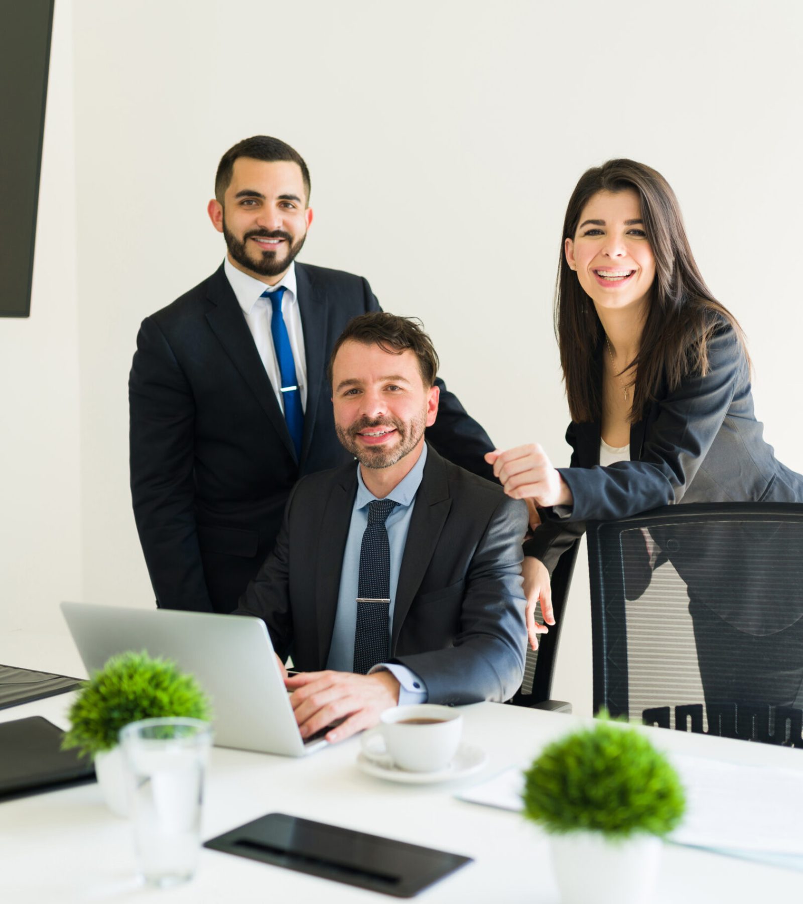 Attractive co-workers feeling happy while working on a business project in the meeting room. Businessmen and colleagues doing paperwork